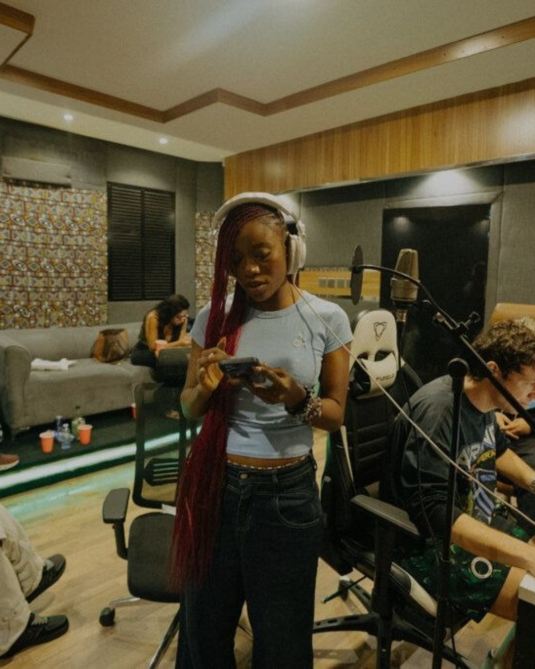 Artist rehearsing in a studio with headphones